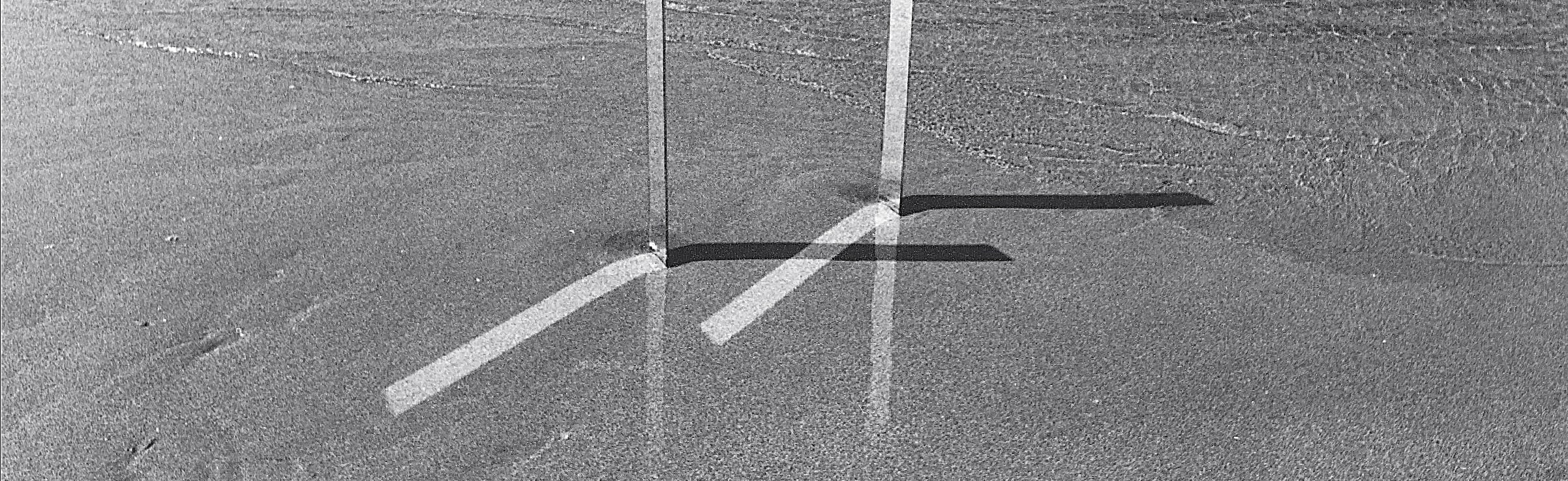 Two mirrors in the sand with an incoming tide