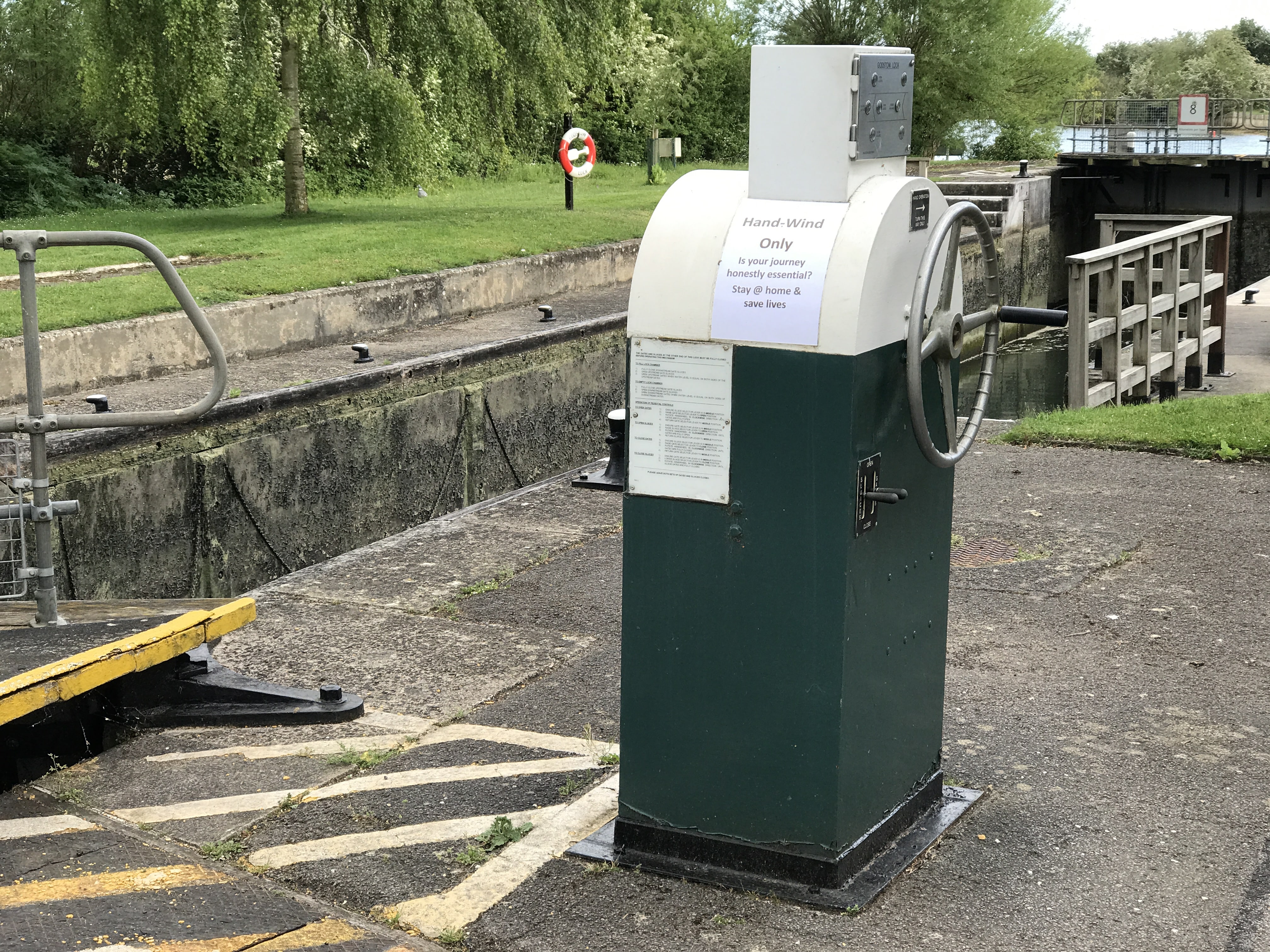 Godstow lock with an announcement that we should not travel unless we really need.